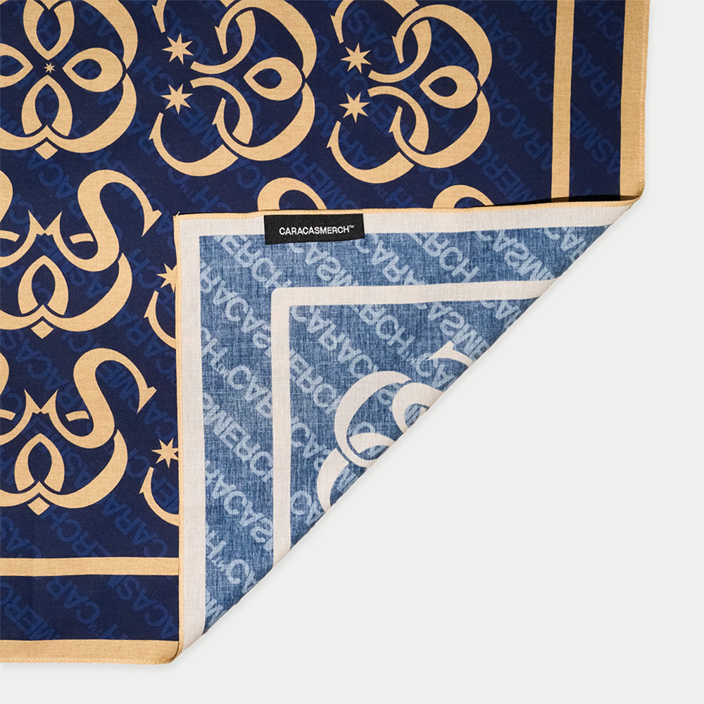 Close-up detail of the CCS Monogram navy bandana by Caracas Merch worn by a model